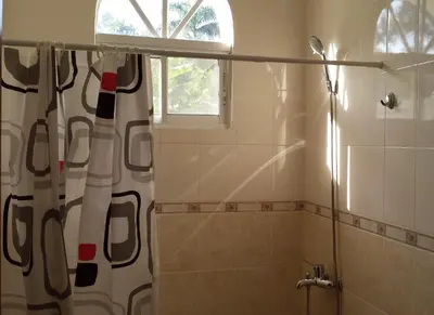 a bathroom with a shower with a shower curtain at Costambar in San Felipe de Puerto Plata