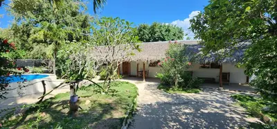 a house with a garden and a swimming pool at Villa Rosa in Punta Rucia