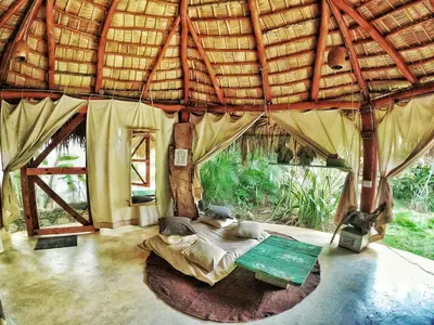 a large room with a bed in a tent at Jungle Hut near Beach - Nature Lovers in Las Terrenas