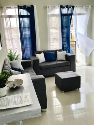 a living room with a couch and a table at Balcón Skyline 2 in Jarabacoa