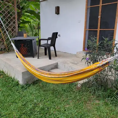 a yellow hammock sitting in front of a house at Apartamento los 3B in Manabao