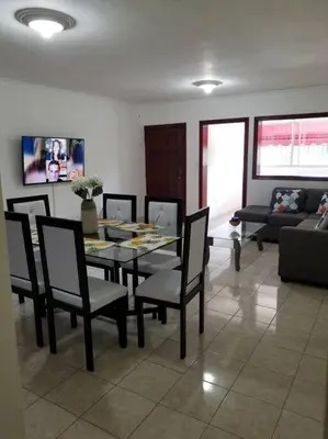 a dining room with a table and chairs and a couch at Apartamento acogedor con equipamiento premium in El Café
