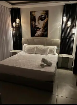 a bedroom with a large bed with avisor at Luxurious and Spacious Condo in Santiago de los Caballeros