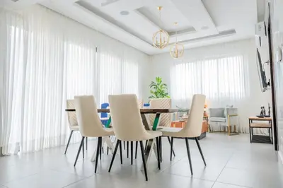 a dining room with a table and chairs at Luxurious and Spacious Condo in Santiago de los Caballeros