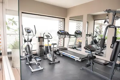 a gym with treadmills and elliptical machines at Luxurious and Spacious Condo in Santiago de los Caballeros