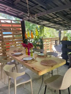 a wooden table and chairs on a patio at Hacienda La Huerta Puerto Plata, 2 BDR in Maimón