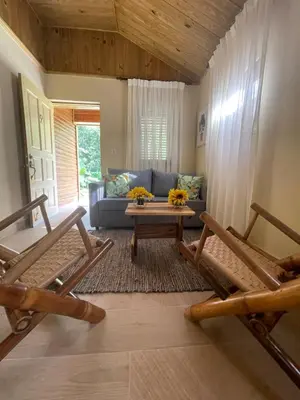 a living room with a couch and a table and two chairs at Hacienda La Huerta Puerto Plata, 2 BDR in Maimón