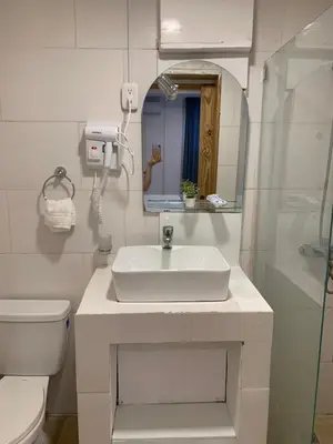 a bathroom with a sink and a toilet and a mirror at Noe Hotel One BedRoom #3 in Punta Cana