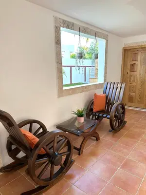 two rocking chairs and a table in a room at Noe Hotel One BedRoom #3 in Punta Cana