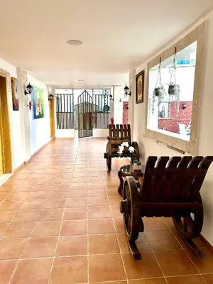 a hallway with chairs and aoyer with a gate at Noe Hotel One BedRoom #3 in Punta Cana