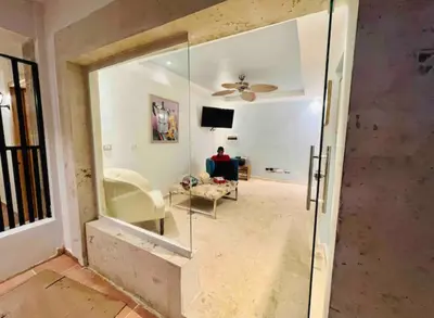 a living room with a glass door leading into a living room at Noe Hotel One BedRoom #3 in Punta Cana
