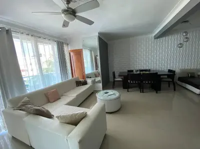 a living room with a white couch and a table at Self check in , moderno, A/C completo Wifi, TV 4K in Santiago de los Caballeros