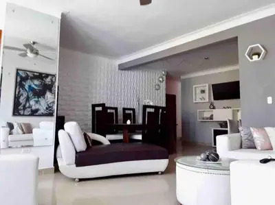 a living room with a couch and a table at Self check in , moderno, A/C completo Wifi, TV 4K in Santiago de los Caballeros