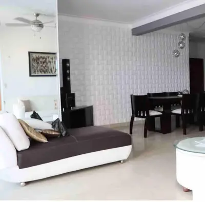 a bedroom with a bed and a table and a piano at Self check in , moderno, A/C completo Wifi, TV 4K in Santiago de los Caballeros