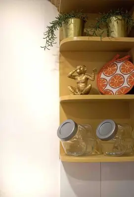 a shelf with jars and a statue of a monkey at Escape 2BR Apartment in Gazcue Close to Colonial Zone in Santo Domingo
