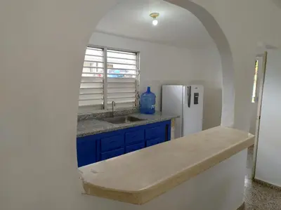 a kitchen with a sink and a refrigerator at Apart cercano al muelle y al malecón de Samana in Santa Bárbara de Samaná