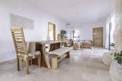 a dining room with a wooden table and chairs at New Beachfront Penthouse Punta Popy in Las Terrenas