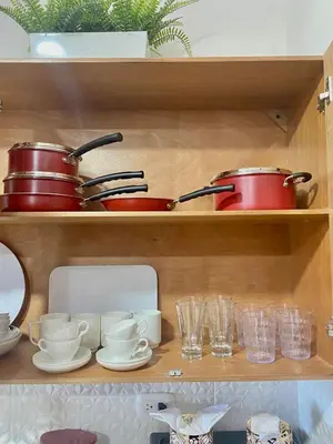 a wooden shelf with pots and pans and glasses at Super Luxurious L6 Sky Blue Apartment in Santo Domingo