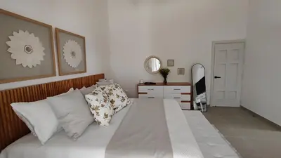 a bedroom with a bed with white sheets and pillows at Luxury 4-Bedroom Villa with Climate Pool in Sosúa