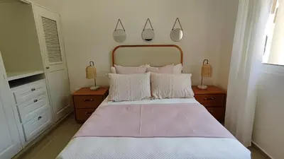 a bedroom with a large bed with white sheets and pillows at Luxury 4-Bedroom Villa with Climate Pool in Sosúa