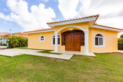 a small yellow house with a large door at Sosua Ocean Village Properties by Calisto Stays in Sosúa