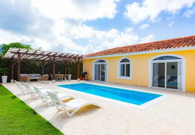 a swimming pool in the backyard of a house at Sosua Ocean Village Properties by Calisto Stays in Sosúa