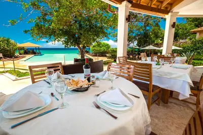 a table with wine glasses and a bowl of fruit at a restaurant at Sosua Ocean Village Properties by Calisto Stays in Sosúa