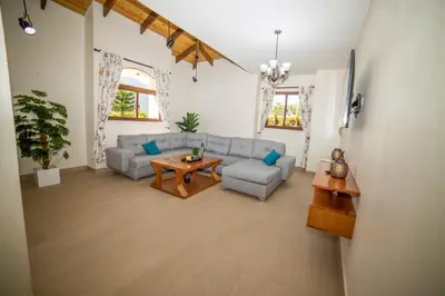 a living room with a couch and a table at ωιℓℓу'ѕ νιℓℓα in Jarabacoa
