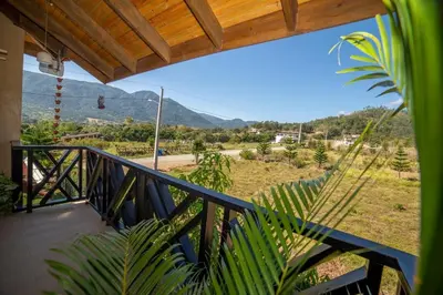 a balcony with a view of a mountain at ωιℓℓу'ѕ νιℓℓα in Jarabacoa
