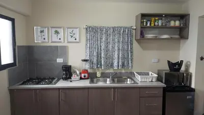 a kitchen with a sink and a stove at Casa Kamanda, Zona Colonial, Santo Domingo in Santo Domingo