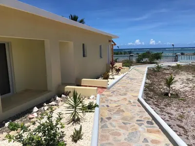 a house with a walkway next to a beach at Punta Rucia Cristal Beach in Punta Rucia
