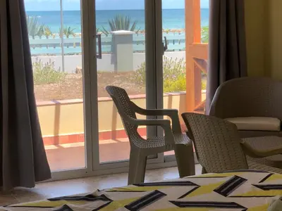 a room with chairs and a view of the beach at Punta Rucia Cristal Beach in Punta Rucia