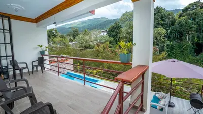 a balcony with a view of a mountain at Peace By The River in Jarabacoa