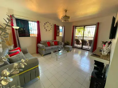 a living room with a couch and a table at Casa Corona Plaza in Santiago de los Caballeros