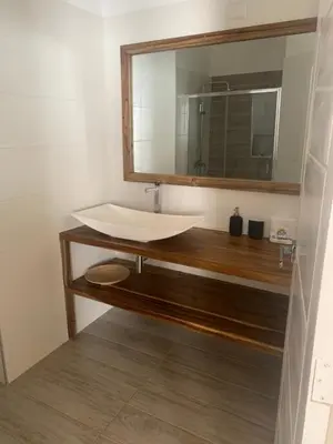 a bathroom with a sink and a mirror at Hotel El Quemaito - Luxury Oceanfront Retreat in Santa Cruz de Barahona