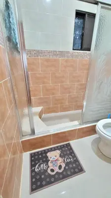 a bathroom with a shower and a mat on the floor at Jarabacoa Mountain Views in Jarabacoa