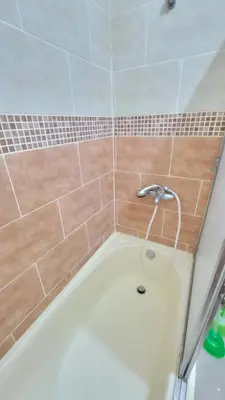 a bath tub with a shower head in a bathroom at Jarabacoa Mountain Views in Jarabacoa