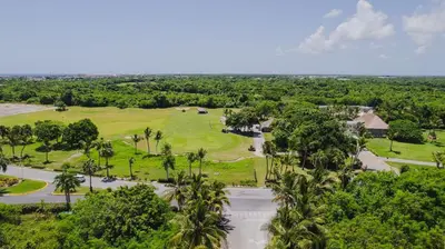 an aerial view of a golf course with palm trees at Hard Rock Golf Cozy 1BR • Pool & Golf Views in Punta Cana