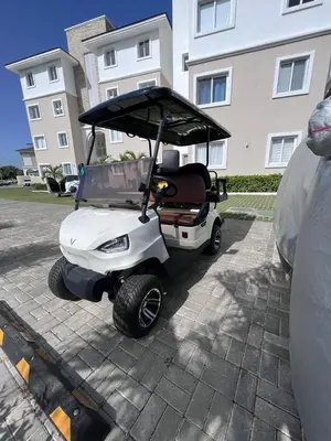 a golf cart parked in front of a building at Luxury Condo with Golf Cart Included in Cana Pearl in Punta Cana