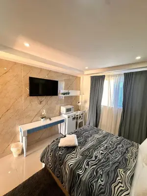 a bedroom with a bed and a desk and a television at Noè Hotel 1 Bedroom #6 in Punta Cana
