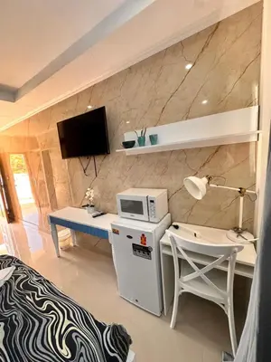 a living room with a desk and a microwave at Noè Hotel 1 Bedroom #6 in Punta Cana