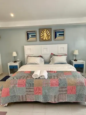 a bedroom with a large bed with two towels on it at Noè Hotel 1 king bedroon #7 in Punta Cana