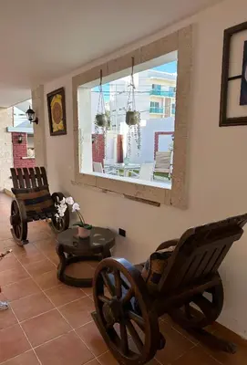 a living room with two rocking chairs and a table at Noè Hotel 1 king bedroon #7 in Punta Cana