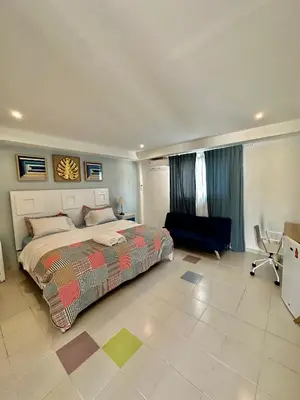 a bedroom with a bed and a chair in it at Noè Hotel 1 king bedroon #7 in Punta Cana