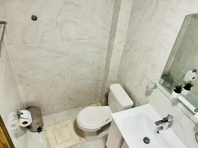 a bathroom with a white toilet and a sink at Noè Hotel 1 king bedroom # 10 in Punta Cana