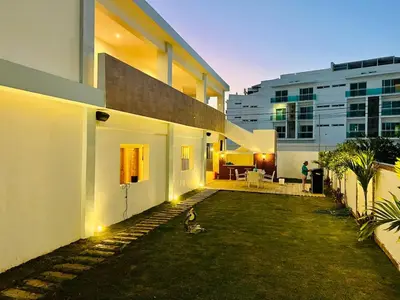 a bird standing in the yard of a building at Noè Hotel 1 king bedroom # 10 in Punta Cana