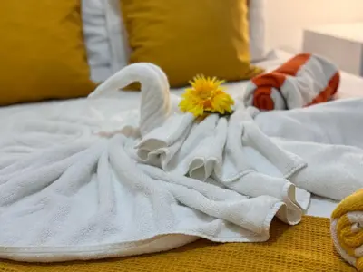 a swan towel on a bed with a flower on it at My Dominicus Beach Retreat in Bayahibe