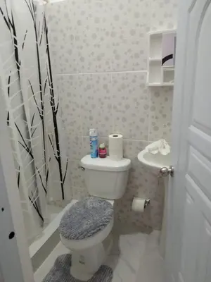 a small bathroom with a toilet and a sink at 4 Bedroom 4 Bath & Laundry Room Apartment in Sosúa