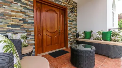 a front door of a house with green pillows at Spacious 3BR APMT- smart speakers Airport transfer in Sosúa