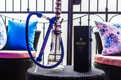 a bottle with a water hose on a table at Spacious 3BR APMT- smart speakers Airport transfer in Sosúa